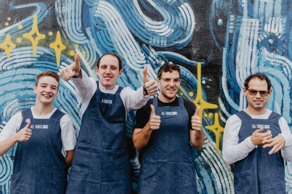 Group of men in aprons giving a thumbs up